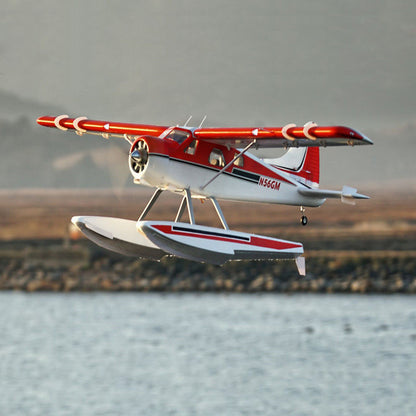 FMS 2000mm Beaver V2 seaplane flying over water with red trim design