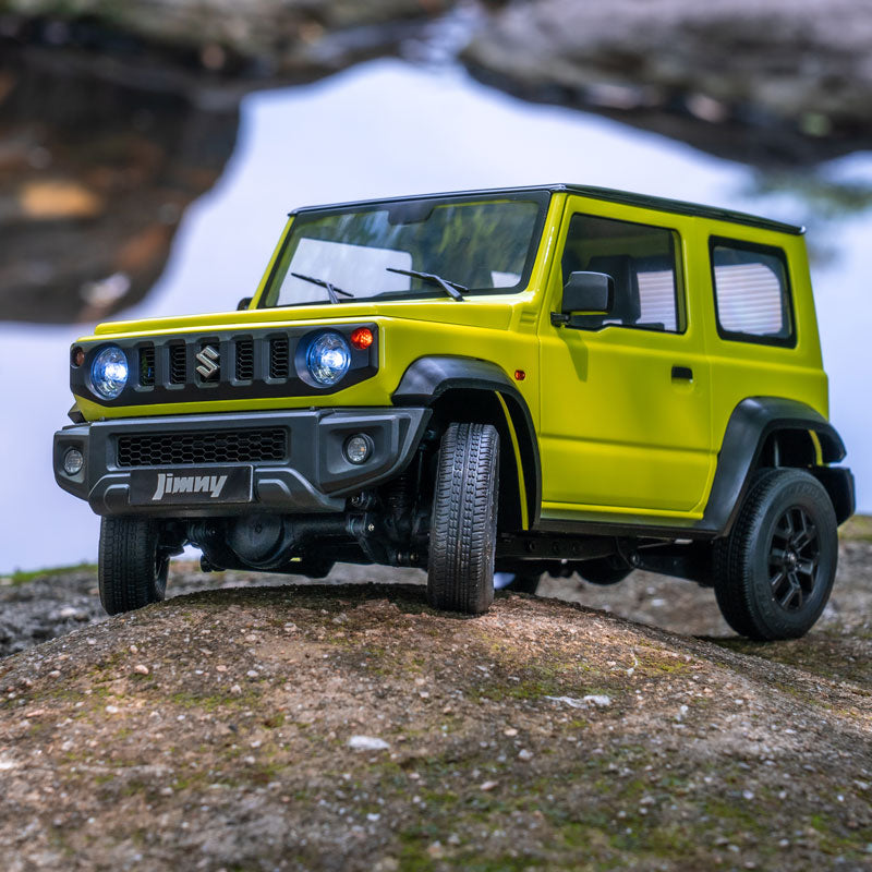 1:12 Suzuki Jimny RC model in green, showcasing off-road capability on rocky surface.