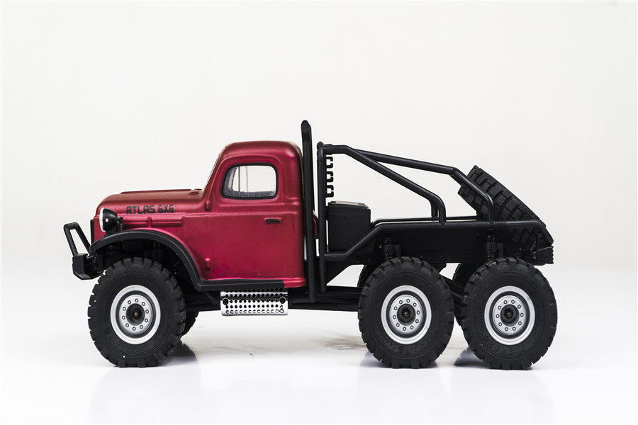 Side view of FMS 1:18 Atlas 6x6 RC crawler in red with black chassis.